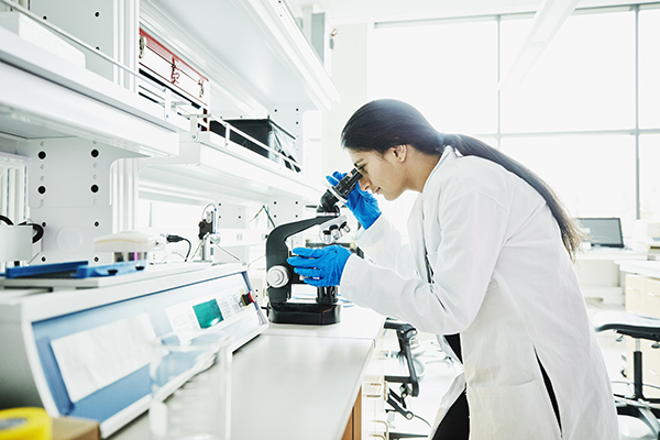 female-scientist-using-microscope-while-working-in-laboratory