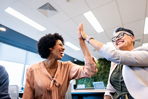 coworkers-doing-high-five-on-the-office
